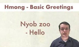 A man stands beside text that reads "Hmong - Basic Greetings" and "Nyob zoo - Hello".